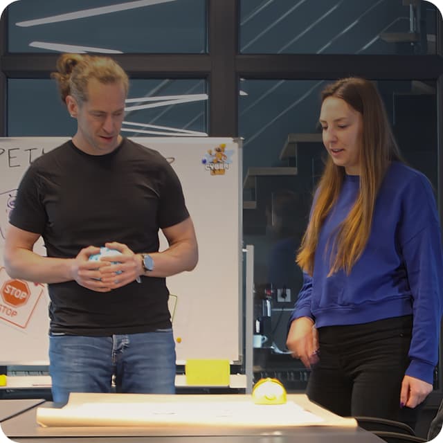 Two engineers whiteboarding a monitoring flow in the Upheave office