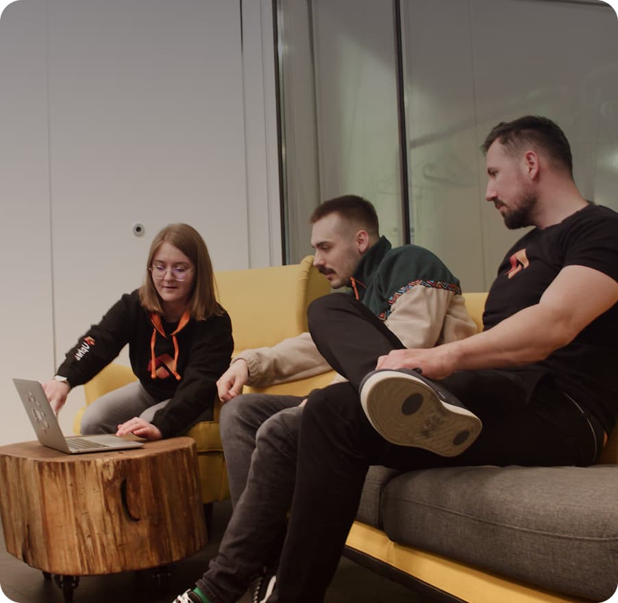 Team gathered on the couch reviewing code together